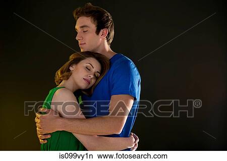 Picture - Young couple hugging with closed eyes. Fotosearch
