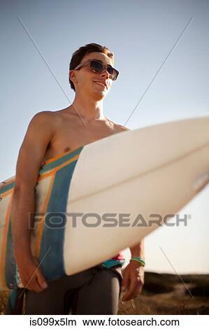 Young man with surfboard View Large Photo Image Picture - Young man with surfboard. Fotosearch