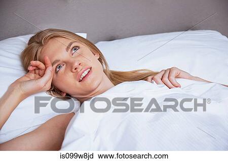 Young woman lying in bed and thinking View Large Photo Image Stock Image - Young woman lying in bed and thinking. Fotosearch