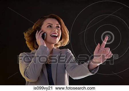 Young woman on cellphone and touching virtual circle View Large Photo Image Stock Image - Young woman on cellphone and touching virtual circle. Fotosearch