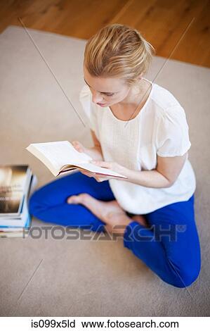 Young woman reading a book View Large Photo Image Stock Image - Young woman reading a book. Fotosearch