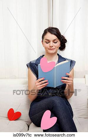 Young woman reading book with heart shapes View Large Photo Image Stock Image - Young woman reading book with heart shapes. Fotosearch