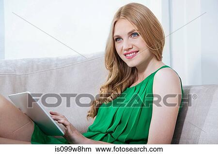 Picture - Young woman using digital tablet. Fotosearch