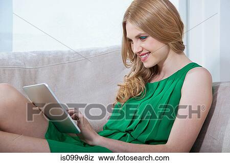 Young woman using digital tablet View Large Photo Image Stock Photo - Young woman using digital tablet. Fotosearch