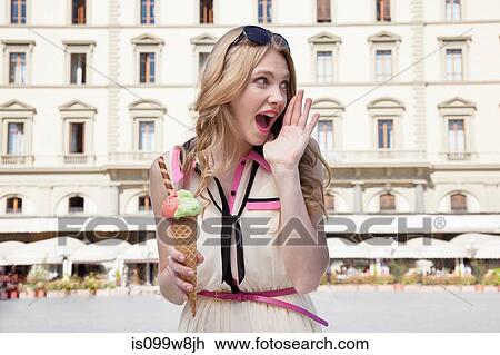 Young woman with ice cream cone, shouting View Large Photo Image Stock Image - Young woman with ice cream cone, shouting. Fotosearch