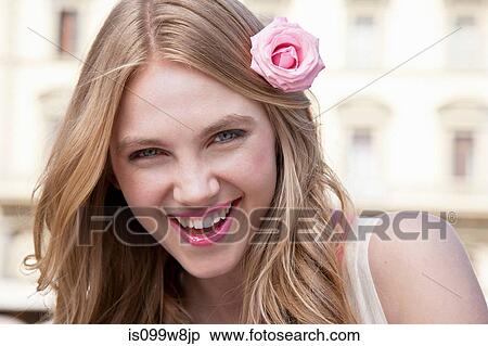 Young woman with pink rose in her hair View Large Photo Image Stock Photography - Young woman with pink rose in her hair. Fotosearch