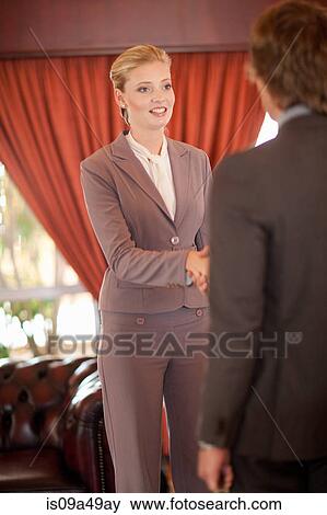 Business people shaking hands in office View Large Photo Image Stock Photo - Business people shaking hands in office. Fotosearch