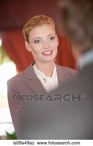 Stock Photo - Business people shaking hands in office. Fotosearch