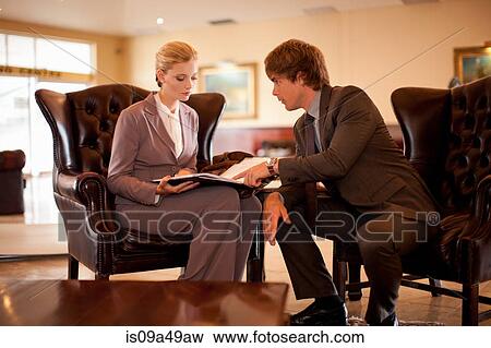 Stock Photo - Business people talking in hotel lobby. Fotosearch