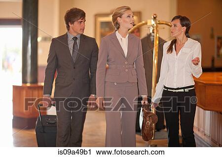 Business people walking in hotel lobby View Large Photo Image Stock Image - Business people walking in hotel lobby. Fotosearch