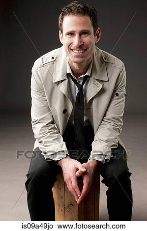 Businessman sitting on wooden box View Large Photo Image Picture - Businessman sitting on wooden box. Fotosearch