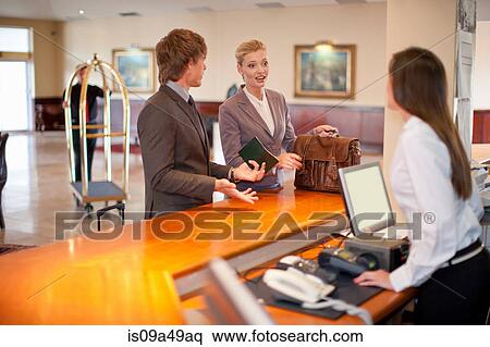 Businesswoman checking in to hotel View Large Photo Image Stock Photography - Businesswoman checking in to hotel. Fotosearch