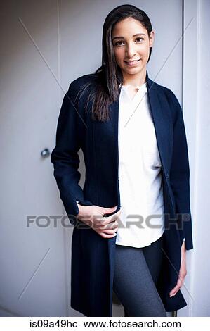 Stock Image - Businesswoman standing indoors. Fotosearch