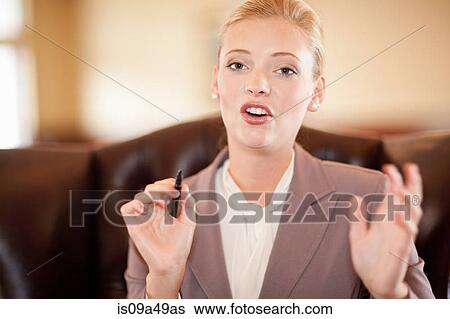 Businesswoman talking at desk View Large Photo Image Stock Photograph - Businesswoman talking at desk. Fotosearch