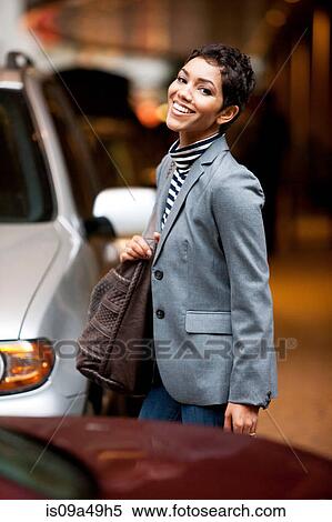 Businesswoman walking in parking lot View Large Photo Image Stock Photography - Businesswoman walking in parking lot. Fotosearch