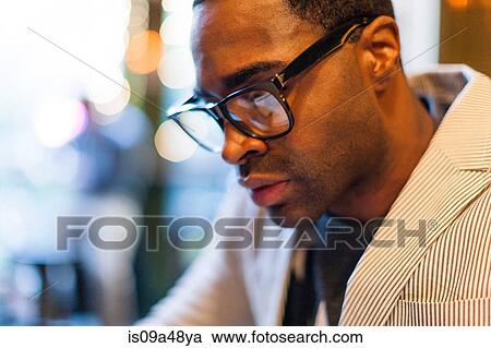 Stock Image - Close up of man wearing glasses. Fotosearch