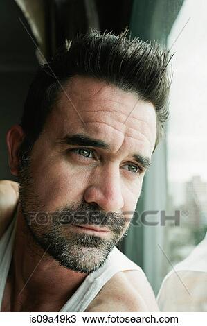 Stock Image - Close up of man's serious face. Fotosearch