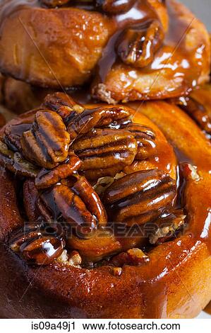 Stock Image - Close up of pecans on sticky buns. Fotosearch