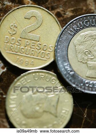 Stock Image - Close up of Uruguayan coins. Fotosearch