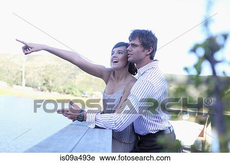 Couple admiring scenery outdoors View Large Photo Image Stock Image - Couple admiring scenery outdoors. Fotosearch