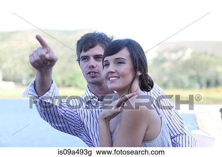 Couple admiring scenery outdoors View Large Photo Image Stock Image - Couple admiring scenery outdoors. Fotosearch