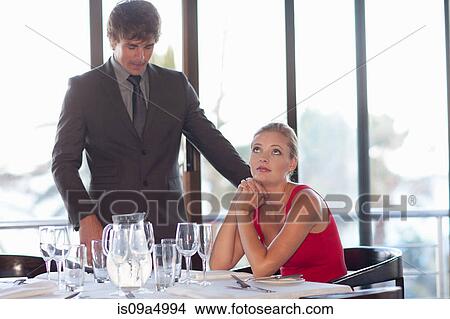 Picture - Couple at restaurant together. Fotosearch