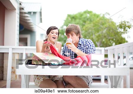 Couple examining shopping bags together View Large Photo Image Stock Image - Couple examining shopping bags together. Fotosearch