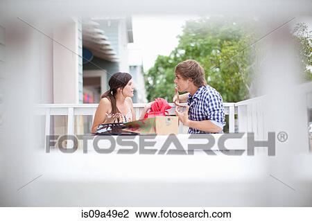 Couple examining shopping bags together View Large Photo Image Stock Image - Couple examining shopping bags together. Fotosearch