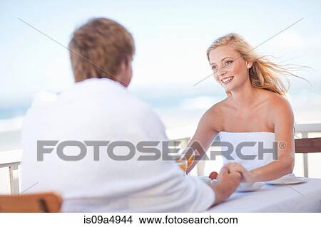 Picture - Couple having breakfast outdoors. Fotosearch