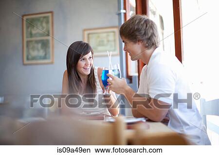 Couple having cocktails in restaurant View Large Photo Image Picture - Couple having cocktails in restaurant. Fotosearch