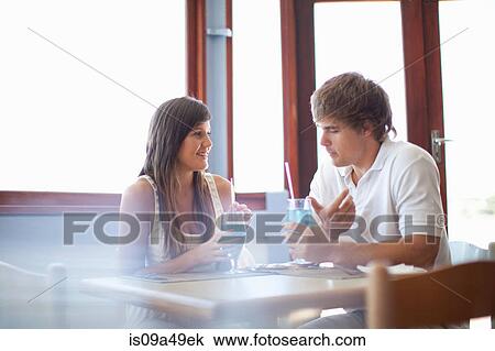 Stock Image - Couple having cocktails in restaurant. Fotosearch