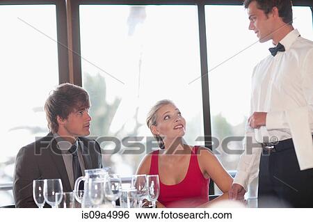 Couple having dinner at restaurant View Large Photo Image Stock Photograph - Couple having dinner at restaurant. Fotosearch