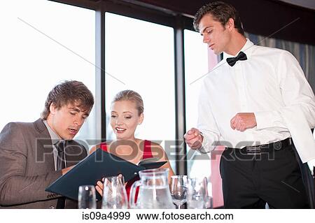 Stock Photo - Couple ordering food at restaurant. Fotosearch