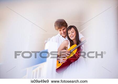 Stock Photo - Couple playing guitar together. Fotosearch