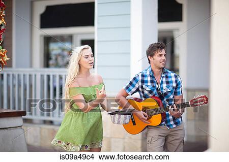 Couple playing music on street View Large Photo Image Picture - Couple playing music on street. Fotosearch