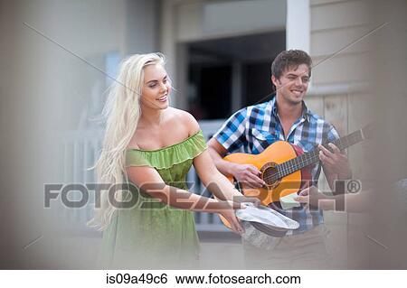 Couple playing music on street View Large Photo Image Stock Photograph - Couple playing music on street. Fotosearch