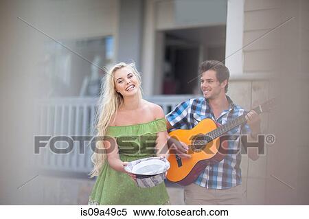 Couple playing music on street View Large Photo Image Stock Photography - Couple playing music on street. Fotosearch
