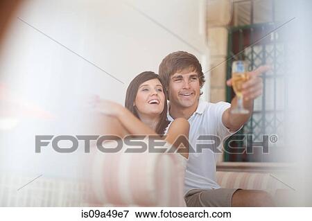 Couple relaxing on sofa together View Large Photo Image Stock Photo - Couple relaxing on sofa together. Fotosearch