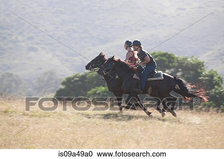 Couple riding horses in rural landscape View Large Photo Image Stock Image - Couple riding horses in rural landscape. Fotosearch