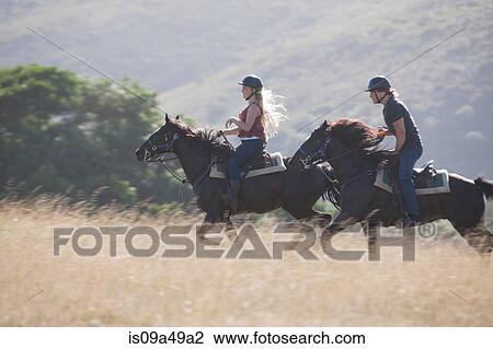 Couple riding horses in rural landscape View Large Photo Image Stock Image - Couple riding horses in rural landscape. Fotosearch