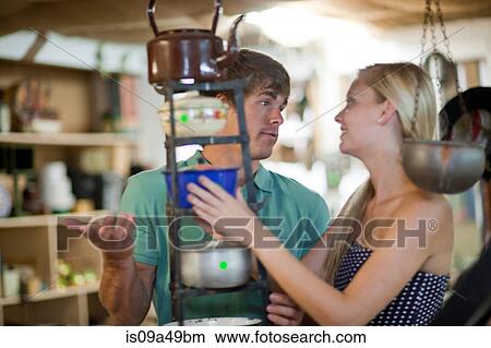 Picture - Couple shopping together in thrift store. Fotosearch