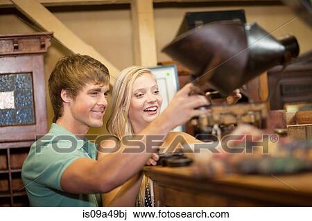 Couple shopping together in thrift store View Large Photo Image Stock Image - Couple shopping together in thrift store. Fotosearch