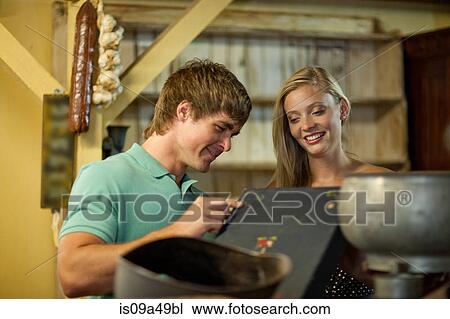 Couple shopping together in thrift store View Large Photo Image Stock Image - Couple shopping together in thrift store. Fotosearch