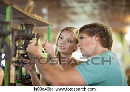 Stock Photography - Couple shopping together in thrift store. Fotosearch