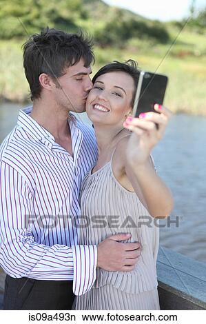 Couple taking picture of themselves View Large Photo Image Picture - Couple taking picture of themselves. Fotosearch