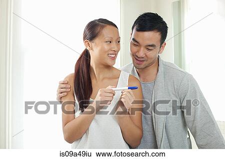 Couple taking pregnancy test in bathroom View Large Photo Image Stock Photograph - Couple taking pregnancy test in bathroom. Fotosearch