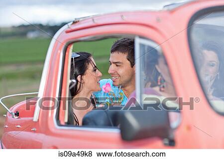 Stock Photo - Couple talking in convertible. Fotosearch