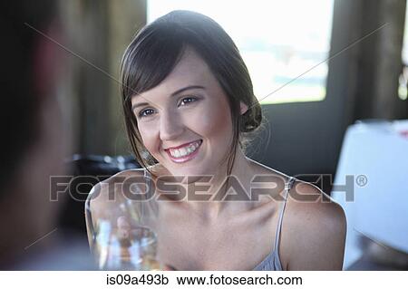 Stock Image - Couple toasting each other with wine. Fotosearch