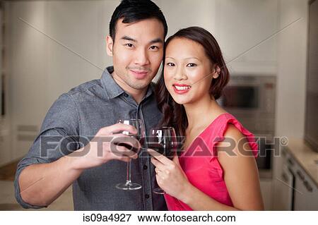 Stock Photo - Couple toasting each other with wine. Fotosearch
