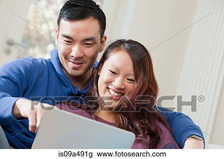 Stock Image - Couple using tablet computer together. Fotosearch